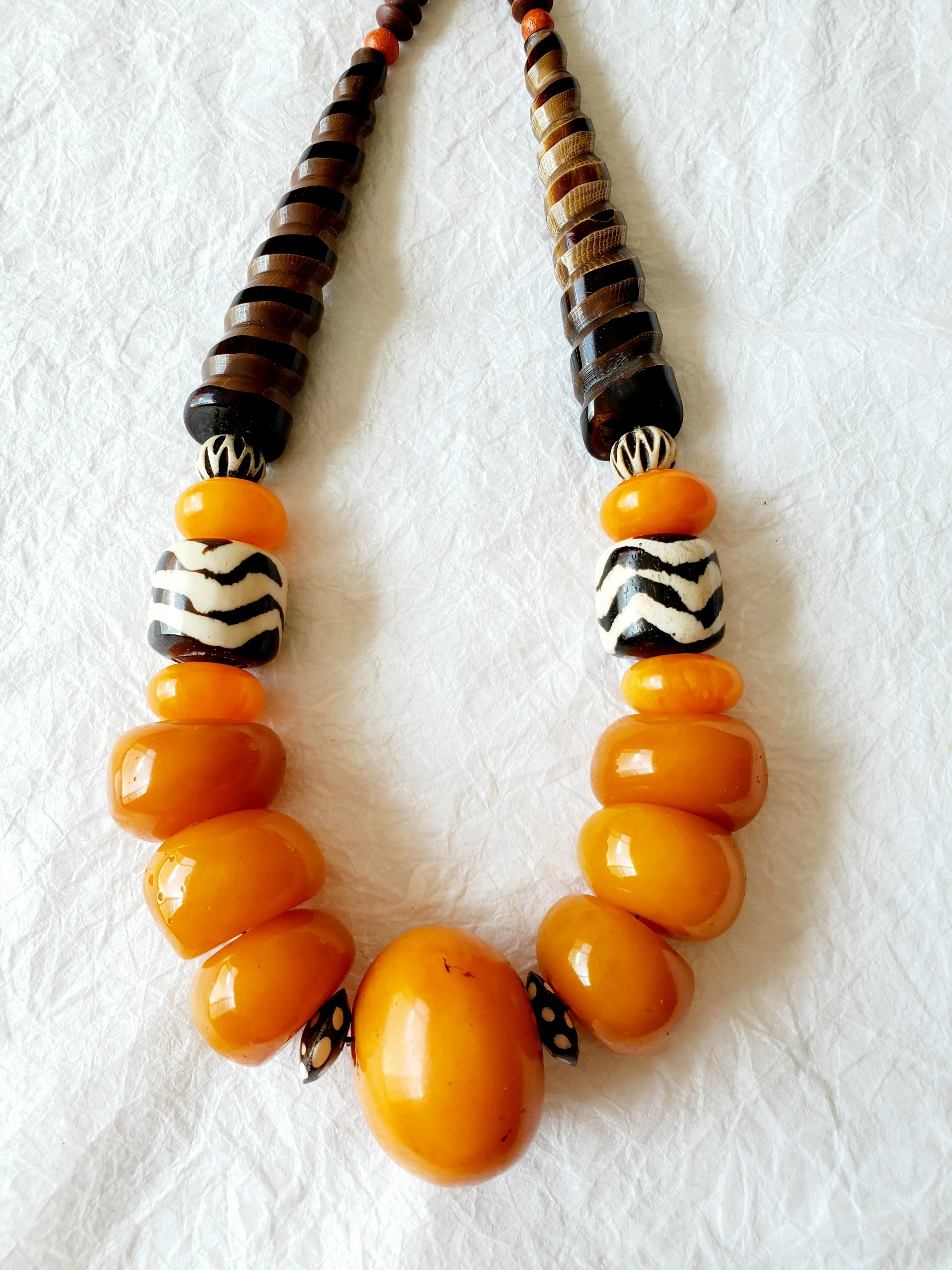 Carved Spiral Horn Bone Cone-shaped Orange Copal Amber Resin Polka Dot Batik Bone Bead Necklace, The Clove