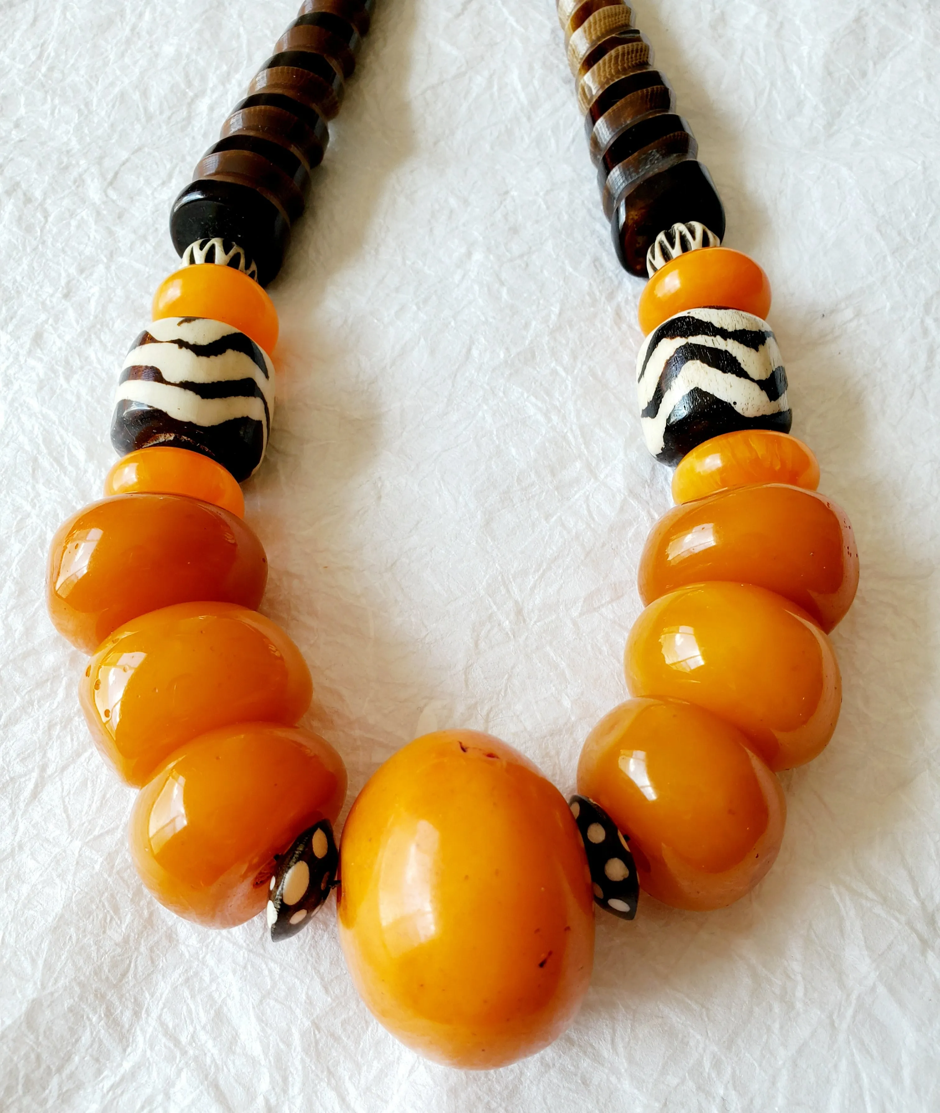 Carved Spiral Horn Bone Cone-shaped Orange Copal Amber Resin Polka Dot Batik Bone Bead Necklace, The Clove