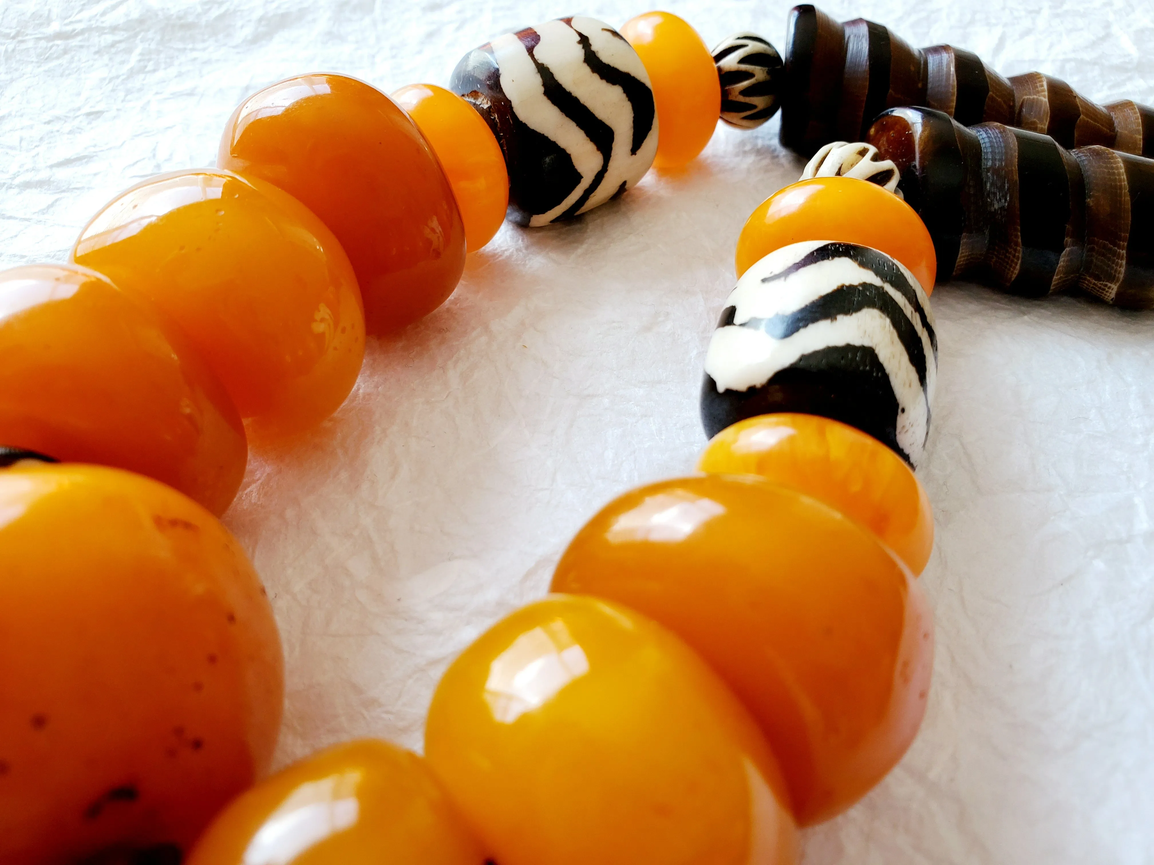 Carved Spiral Horn Bone Cone-shaped Orange Copal Amber Resin Polka Dot Batik Bone Bead Necklace, The Clove