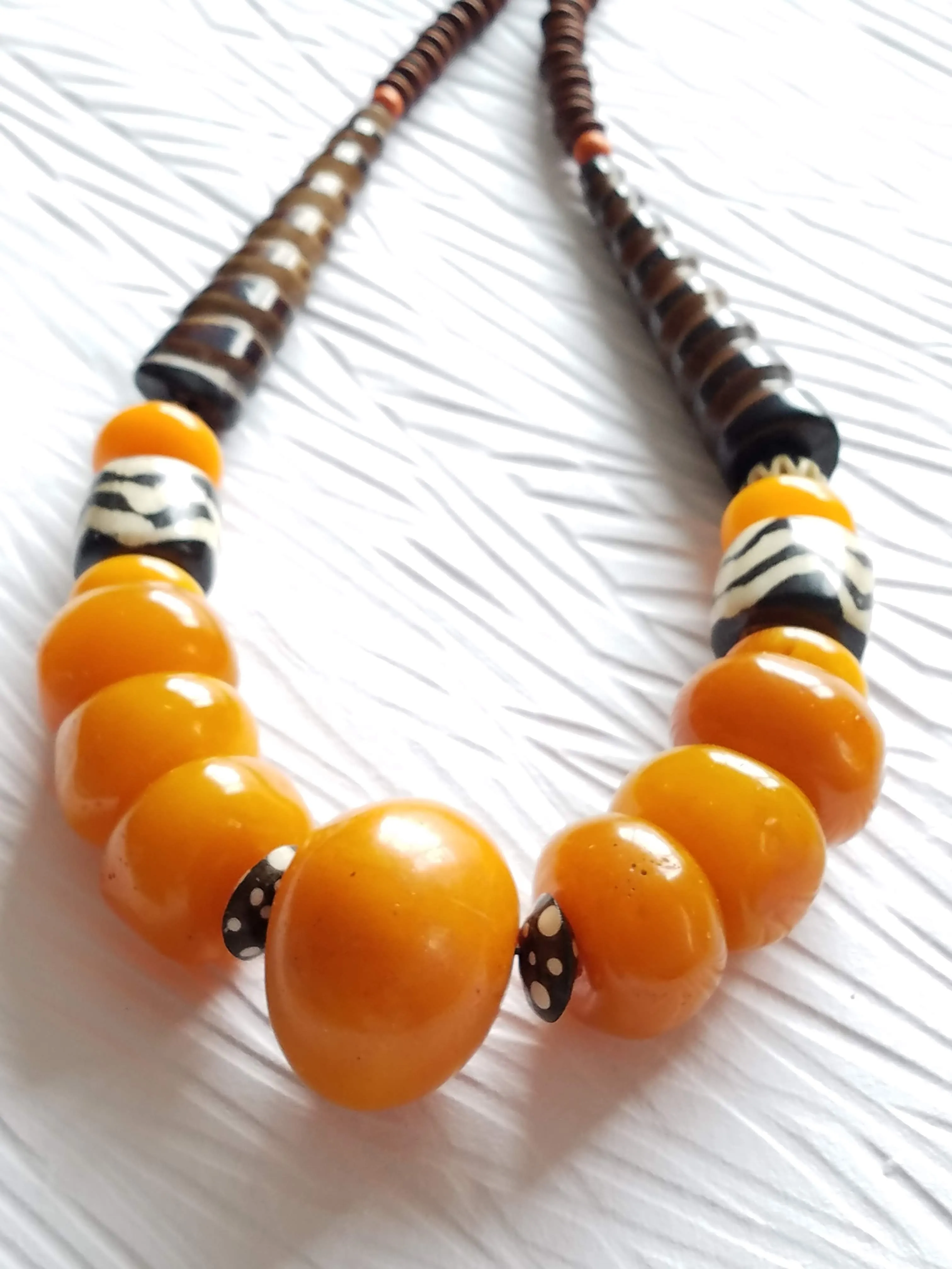 Carved Spiral Horn Bone Cone-shaped Orange Copal Amber Resin Polka Dot Batik Bone Bead Necklace, The Clove