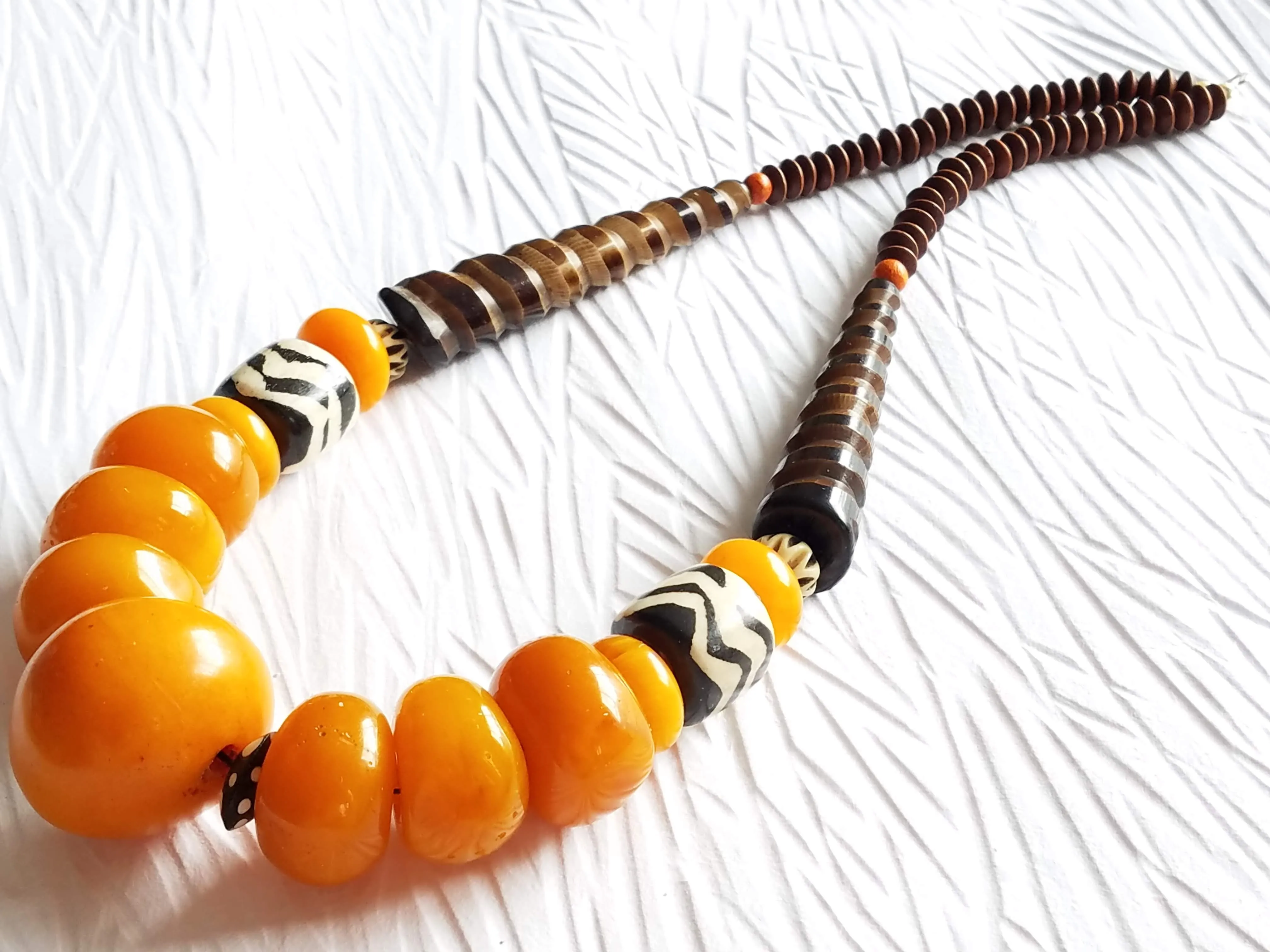 Carved Spiral Horn Bone Cone-shaped Orange Copal Amber Resin Polka Dot Batik Bone Bead Necklace, The Clove