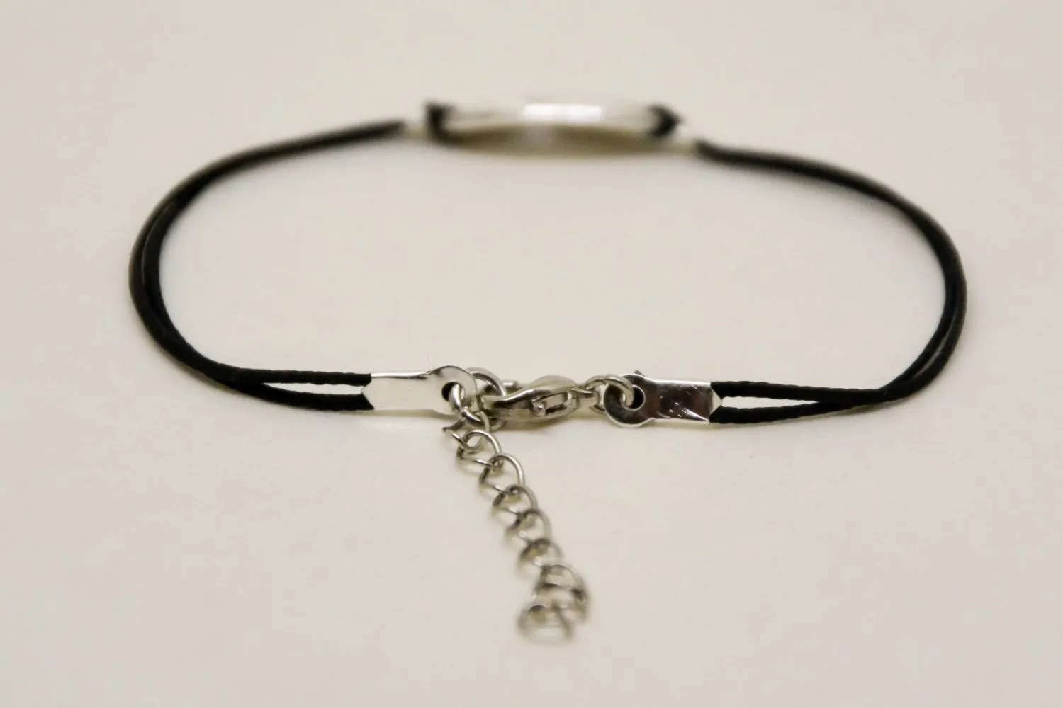 Women bracelet with silver cross round charm, black cord